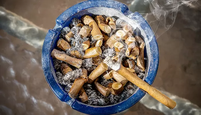 Cigarette Smoke Polluting Air From Ashtray